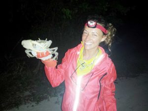 Graduate student Kinsey Tedford with one of her subjects during the land crab study.