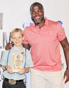 Junior category winner Ethan Spencer, 10, with American actor and comedian Reno Wilson