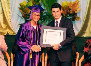 Top student Ruth Harris receives the Ernst & Young Highest Academic Achievement Award from EY's Marco Calleja.
