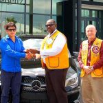 Raffle winner drives away in new car