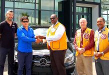 Raffle winner drives away in new car