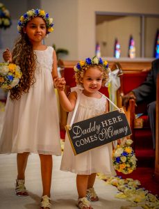 Flowers girls Amie Ebanks and the couple's 2-year-old daughter Kaelyn Scott walk down the aisle of the Wesleyan Holiness Church.