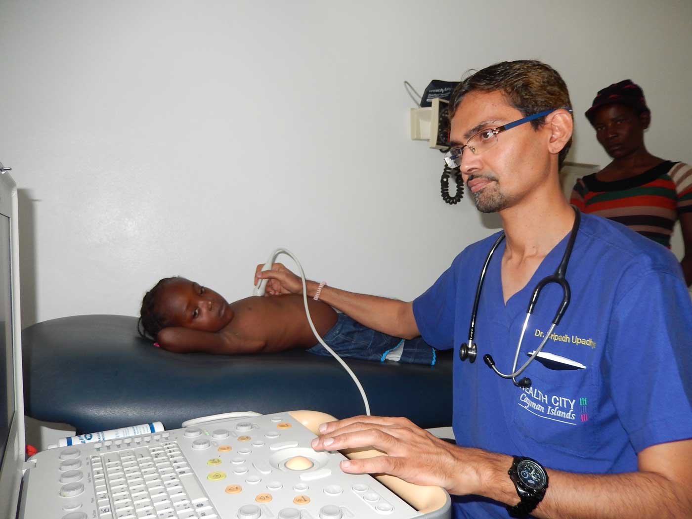 Senior Pediatric Cardiologist Dr. Sripadh Upadhya of Health City Cayman Islands examined nearly 50 young patients per day in Port-au-Prince. Sixty of them were chosen to come to Grand Cayman for medical procedures.