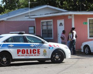 Police attend the scene of an Aug. 7 shooting on Rock Hole Road in George Town. The incident was one of several violent crimes for which police have made quick arrests since the start of the month. – Photo: Brent Fuller