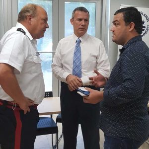 Superintendent Graham speaks with Wil Pineau, CEO of the Chamber of Commerce, and Waqas Khan, technical sales consultant for Island Electronics Ltd., after the retail business forum.