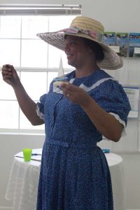 Laura Walton leads a craft activity dressed as an old-time Caymanian.