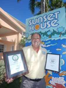 Keith Sahm of Sunset House with his TripAdvisor Certificates of Excellence.