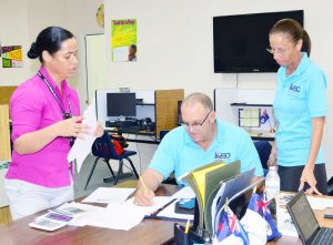 ESO Accounts Officer Joyce Christian with statistical officers Ivan McLean and Narnia Ebanks tabulating the survey results.