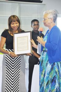 Church clerk Dean Barnett, right, presents a certificate to Denise Williams-Watson of the CAYS Foundation.