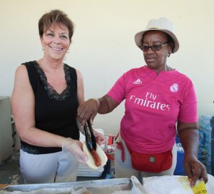 Grade 4 teacher Marty Minton and kindergarten helper Dawn Brooks serve hot dogs.