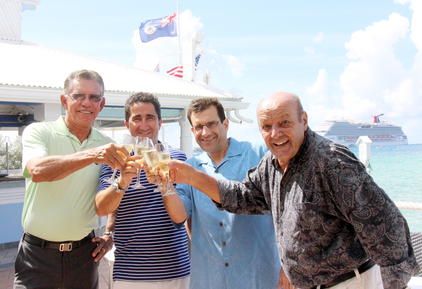Naul Bodden, Luciano De Riso, Reno Mancini and Clemens Guettler toast the sale of The Wharf restaurant. - PHOTO: JAMES WHITTAKER