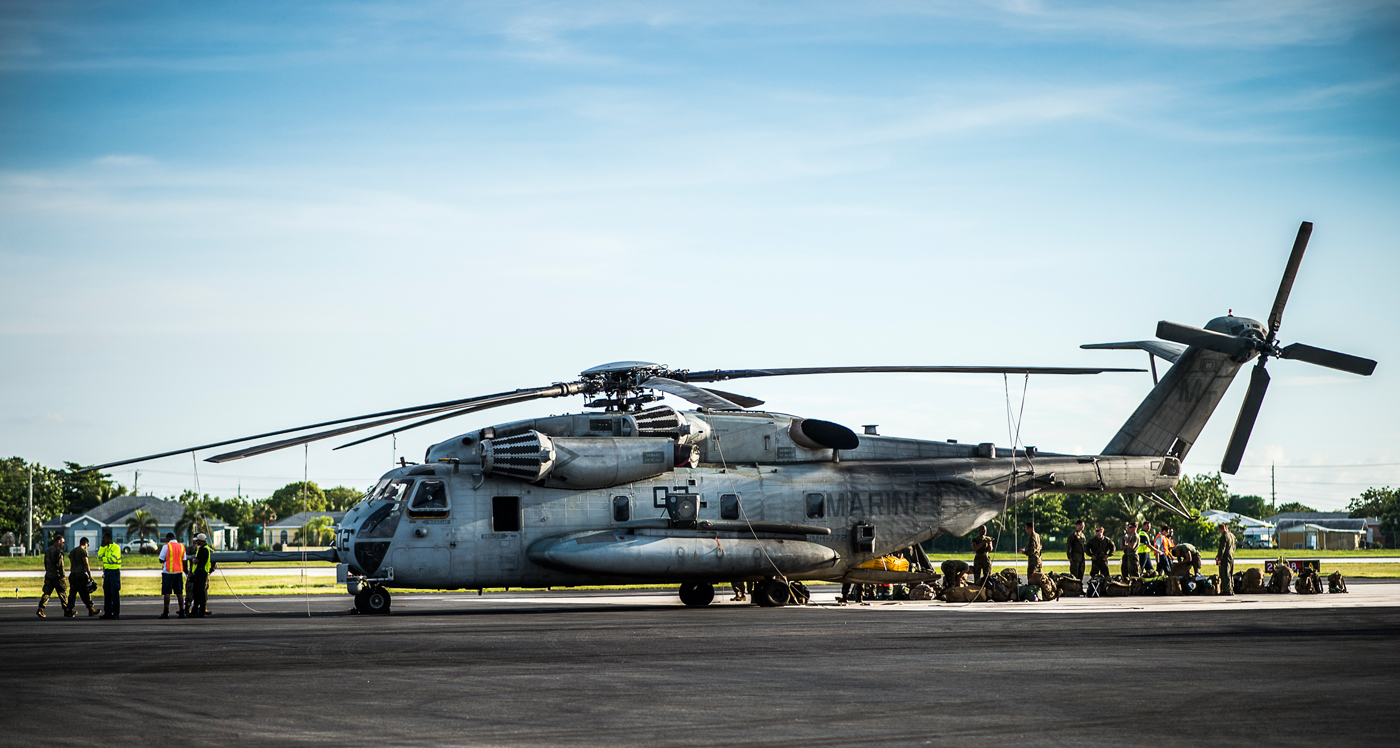 U.S. military helicopters land at Owen Roberts International Airport Tuesday afternoon, positioning equipment and 100 members of the U.S. Marines and Army in preparation for Haiti hurricane relief operations. - Photo: Taneos Ramsay