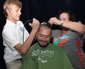 Teacher Mark Leary gets his head shaved by a student and member of the Baldrick's Foundation. -Photo: Jewel Levy
