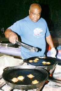 Kenworth Connor cooks a batch of fritters at Gimistory some years ago.