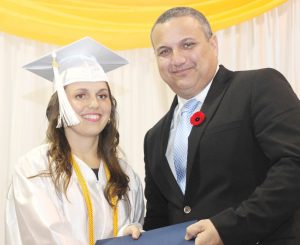 Kathleen Westin receives her degree from Deputy Governor Franz Manderson.