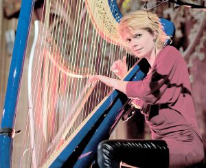 Catrin Finch with her harp on stage. - Photo: Daniel Whiston