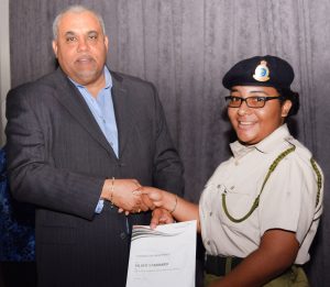 Cayman Islands Cadet Chanutae Martinez receives her Duke of Edinburgh's silver award from Minister for Community Affairs, Youth and Sports Osbourne Bodden.