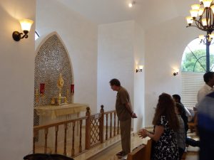 A congregant takes a quiet moment inside the chapel. - PHOTO: CAROL WINKER