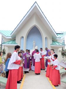 Archbishop Kenneth Richards leads the dedication prayers outside the new chapel, flanked by St. Ignatius pastor Father Suresh Rajaian, left, and former pastor Father Devon Nash. - PHOTO: CAROL WINKER