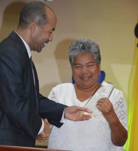 Pastor Shian O’Connor, president of the Cayman Islands Conference of Seventh-day Adventists, presents the 2016 Quartet Festival trophy to Idalee Cynthia Scott in recognition of her contribution to music in the Cayman Islands.