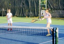Junior tennis players have a ball
