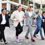 Men go mincing through Camana Bay for charity
