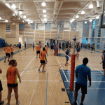 Corporate indoor coed volleyball under way
