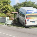 Public bus slams into wall with two passengers on board