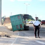 Truck tips over on roundabout, blocking road for hours