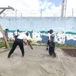 Young inmates building their own basketball court in prison
