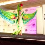 Miss Cayman Anika Conolly shows off parrot costume at Miss Universe pageant