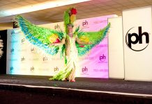 Miss Cayman Anika Conolly shows off parrot costume at Miss Universe pageant