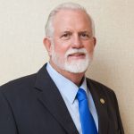 Former government minister Mike Adam charged with assault