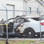 Man arrested in police car arson