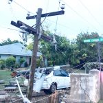 Car takes down wall, two power poles