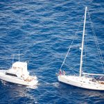 Fishermen tow disabled sailboat to safety