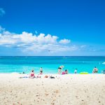 Tourism Ministry: CDC advisory will not ‘negatively impact’ sector Tourists relax on Grand Cayman's Seven Mile Beach