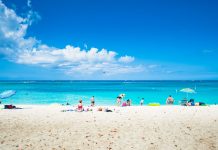 BA chief hopeful of increased Caribbean travel after 17 May Tourists relax on Grand Cayman's Seven Mile Beach