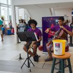 Music students entertain passing travellers to raise funds