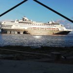 Tugboat pushes drifting cruise ship into position