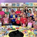 Swimmers donate books to primary students