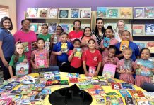 Swimmers donate books to primary students