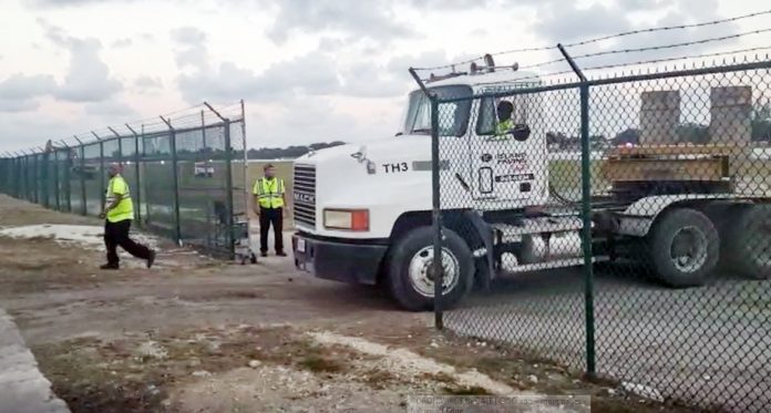 An Island Paving truck leaves the airport area as work on the ru
