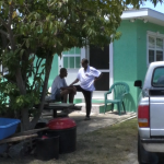 Living in lockdown, Cayman residents cooperative Michael Williams and his father remain in their yard during the 24-hour curfew.