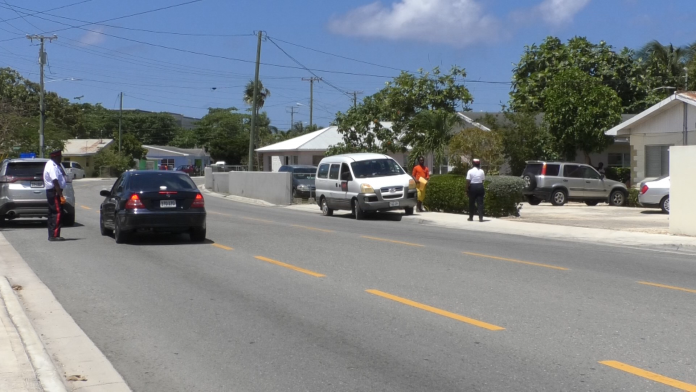 Police officers carry out a road block to catch people who break curfew hours.