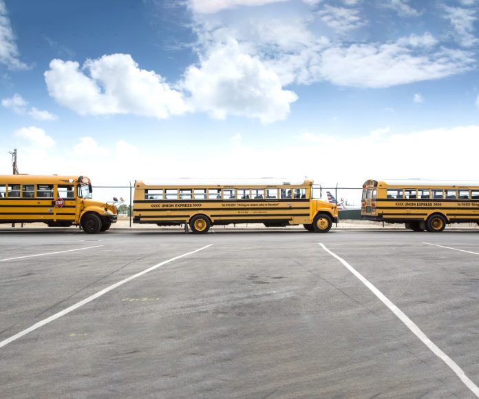 Buses line up at the airport to take returning students to isolation units