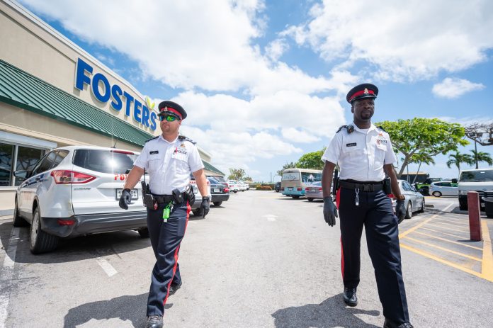 Police on high visibility patrol outside Fosters supermarket in George Town