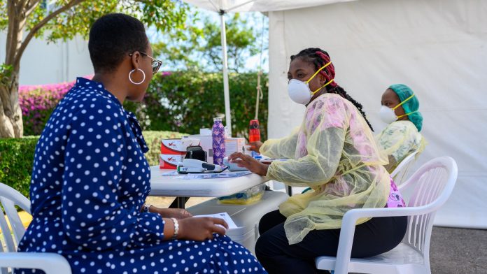 Nurse Shanna Gay Grant and Dr. Zanele Balang run through coronavirus vetting procedures at the CTMH Doctors Hospital