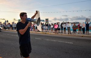 Ben Somerville leads protesters in 2019 during a demonstration about the port project and climate change