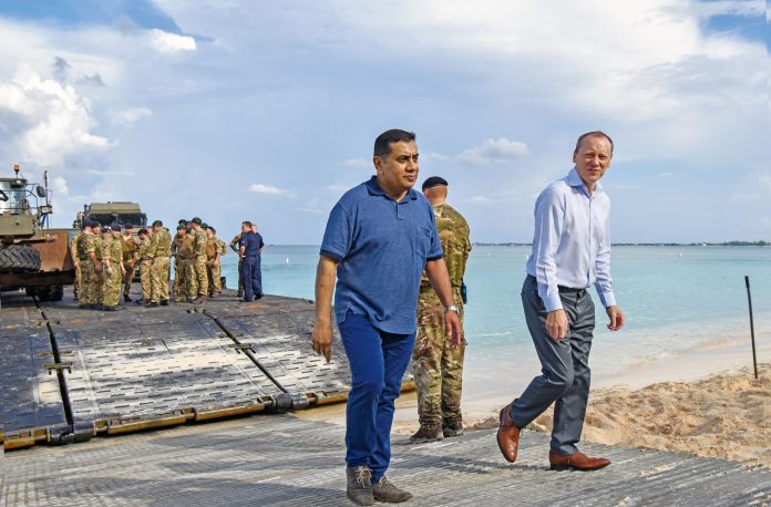 More severe impacts from hurricanes is one possible consequence of climate change. Governor Martyn Roper (right) pictured alongside RFA Mounts Bay which provides hurricane relief support in the region, said the UK is ready to work with Cayman.